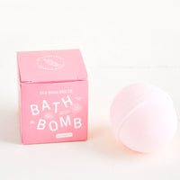Magnolia: Pink colored, round bath bomb with pink boxed packaging