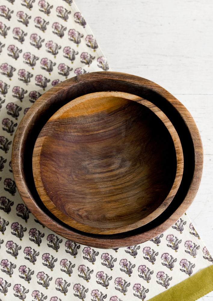 Two nesting olivewood bowls.