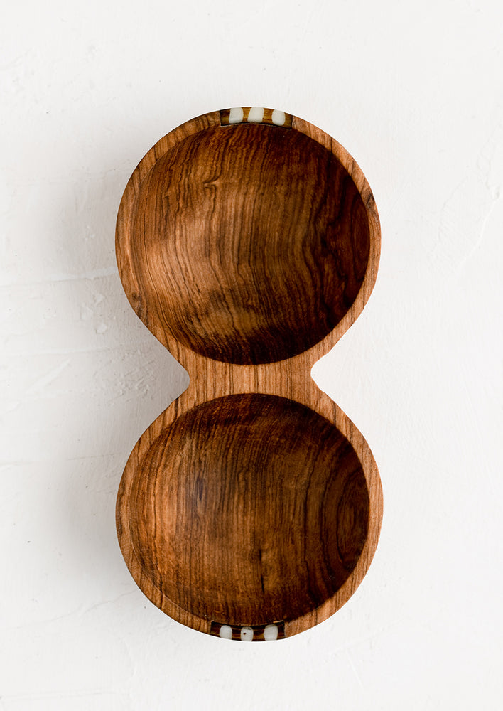 A double well wooden bowl with small bone detailing.