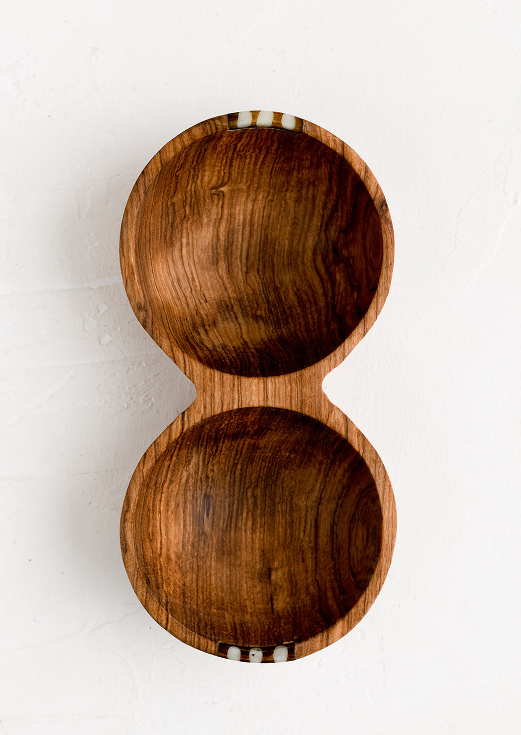 1: A double well wooden bowl with small bone detailing.