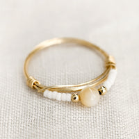 Size 5 / White: A gold wire ring with white and tan beads.