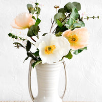 2: Glossy ceramic vase with side handles, housing floral bouquet with poppies and wild basil flowers