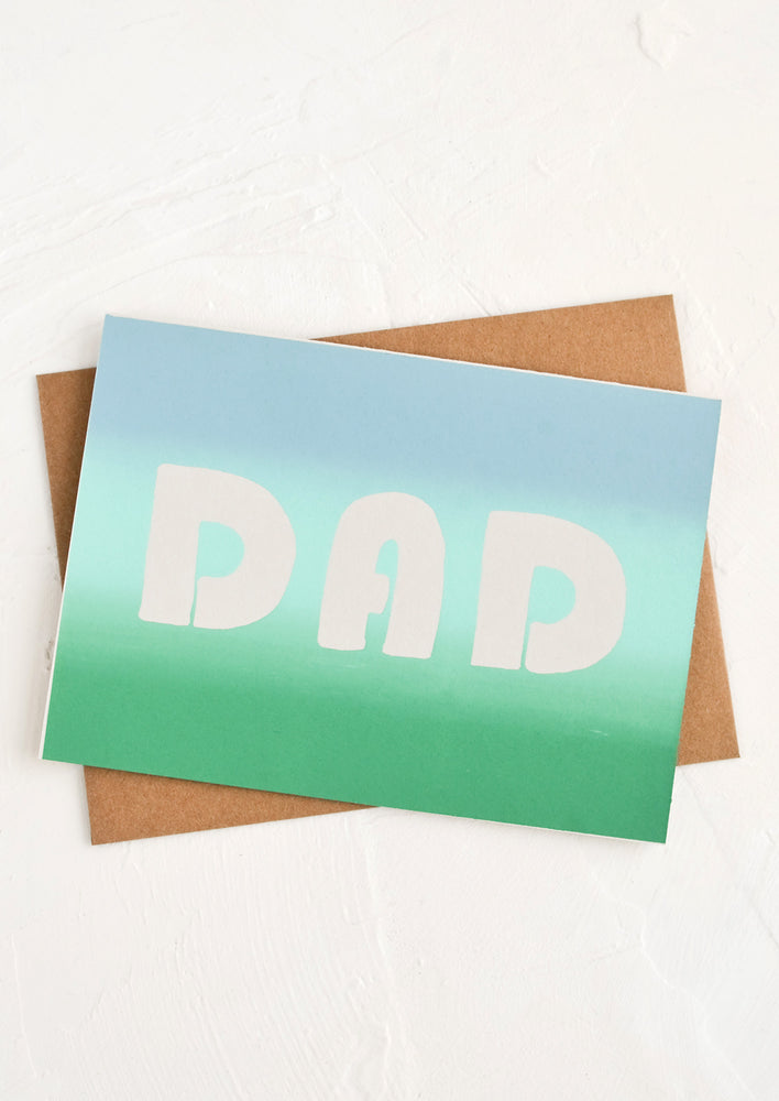 A father's day greeting card with "DAD" on front in ombre.