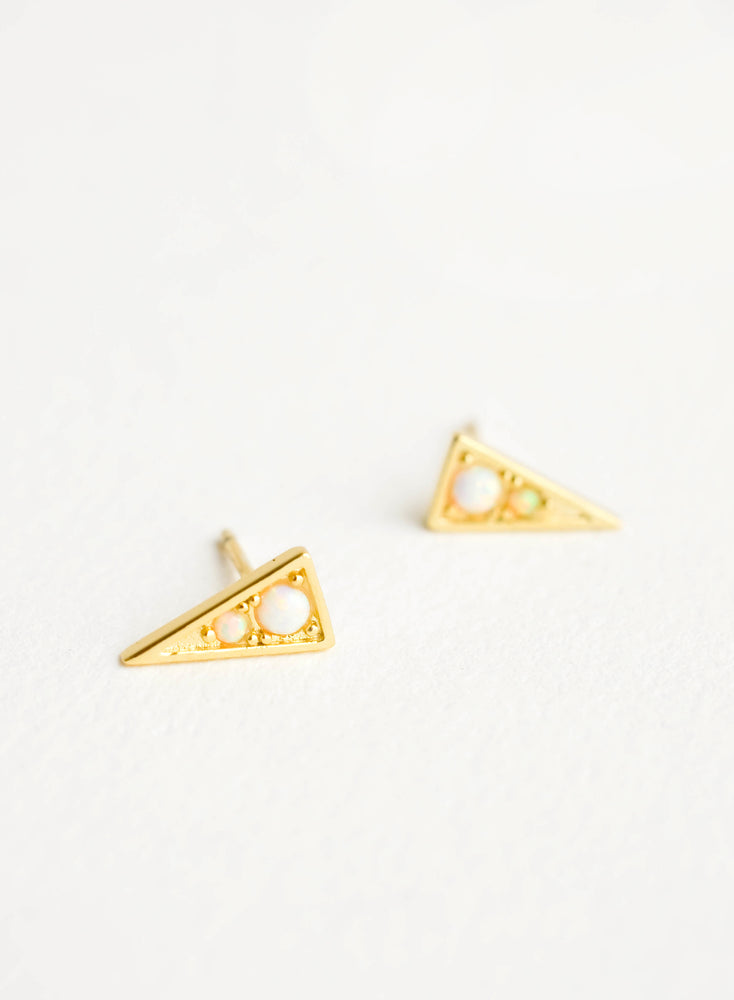 Gold colored stud earrings in shape of pointy triangle with round opal stone inset.