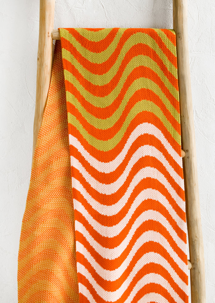 A wave print scarf in orange, light pink and chartreuse.