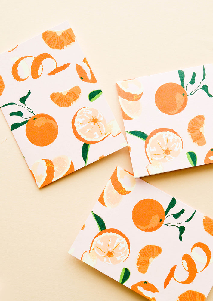 Set of cards with pink background and allover orange citrus print