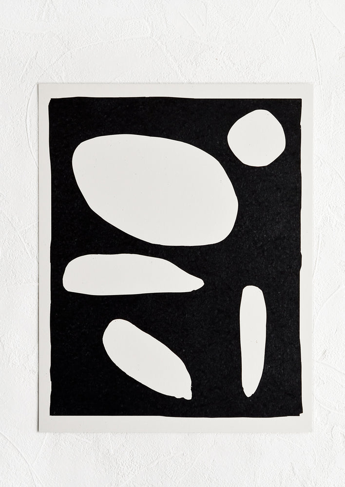 Art print of abstract white shapes on black background with white border.