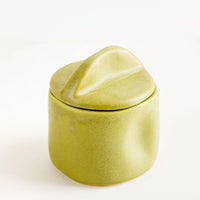 Avocado: A green ceramic jar with handled lid.
