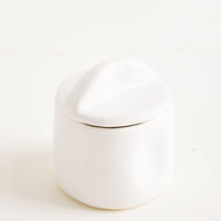 Snow: A white ceramic jar with lid.