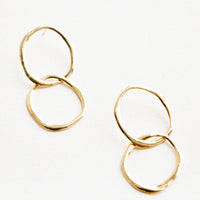 1: Gold drop earrings consisting of two interwoven hammered circles.