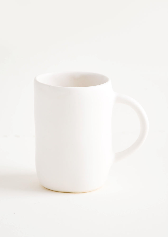 Snow: Ceramic mug with handle in matte white glaze.
