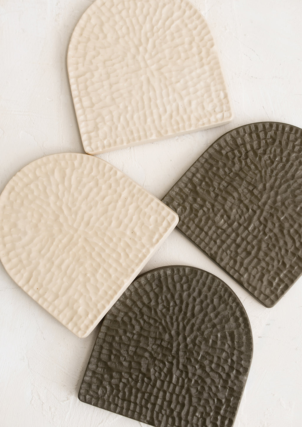 1: Textured, arch-shaped coasters in two colors.