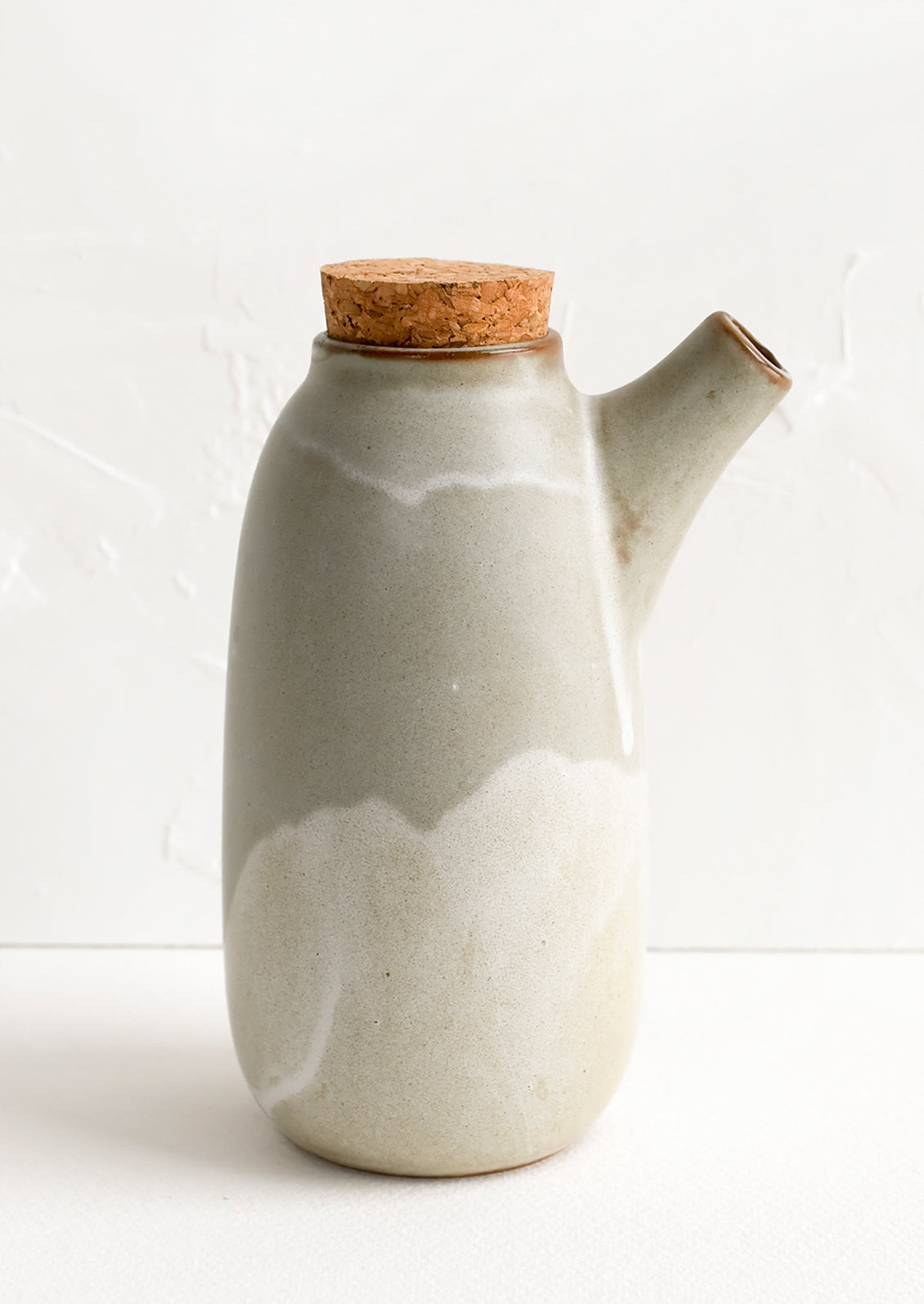 A spouted pitcher with cork stopper in matte grey ceramic.