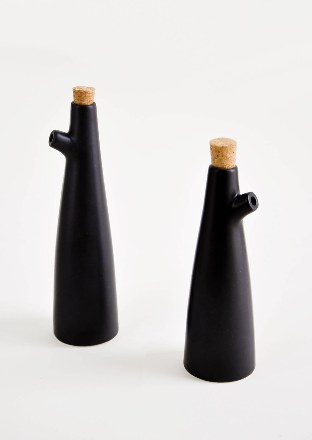 Small / Black: Ceramic cruets for oil & vinegar, one taller than the other. Matte black glaze, cork stopper as lid.
