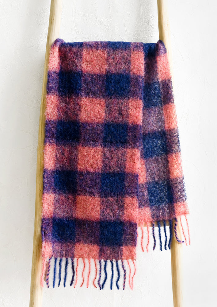 A cozy scarf in pink and blue check print.