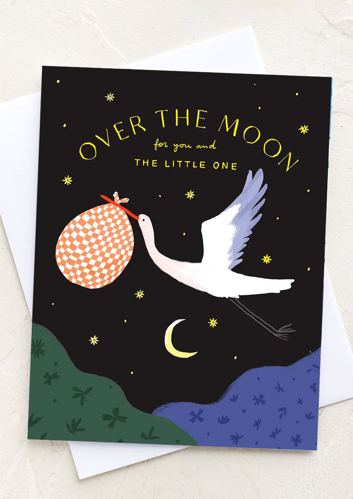 A card with stork illustration, text reads "Over the moon for you and the little one".