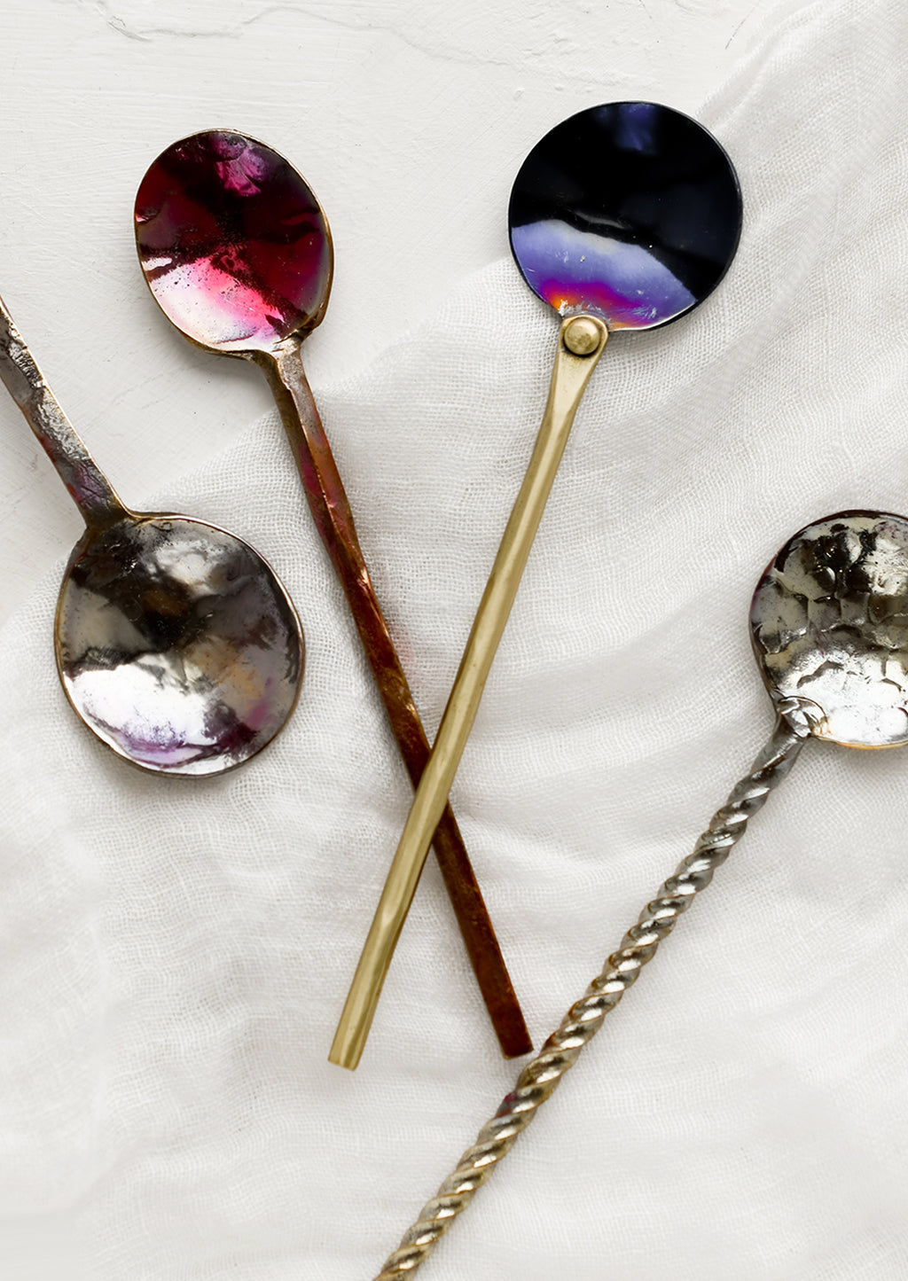 2: A variety of oxidized metal spoons in different finishes and handle types.