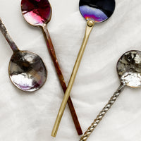 2: A variety of oxidized metal spoons in different finishes and handle types.