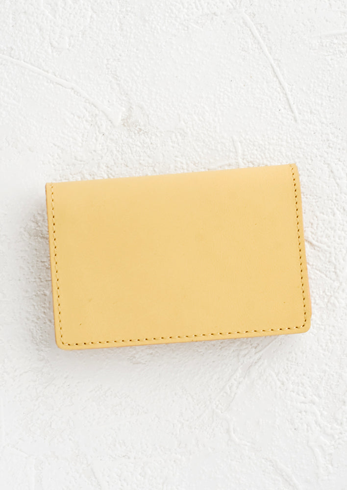 A small leather cardholder wallet in vanilla.
