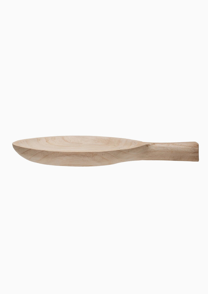 A round paddle shaped tray in natural paulownia wood.