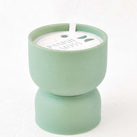 Spanish Moss: Scented candle in hourglass-shaped matte ceramic containers in sea green.