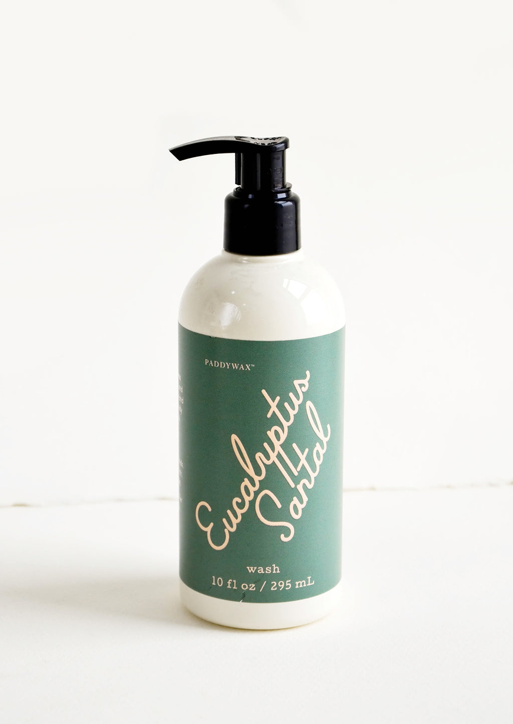 Eucalyptus Santal: Liquid soap packaged in ivory and black pump bottles with pink and dark green label