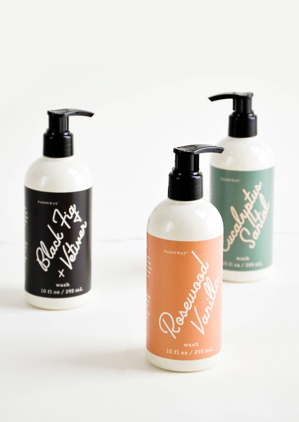 2: Liquid soap packaged in ivory and black pump bottles with modern label design
