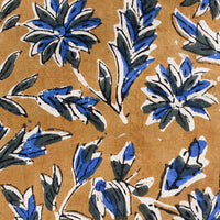 3: A block printed pillow with floral motif in blue and black on tan.