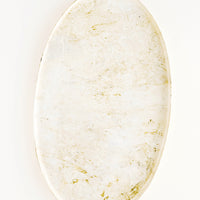 1: Oval shaped decorative tray with lipped rim, covered in a shiny enamel finish in an off-white, marble-like pattern.
