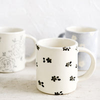 3: Handmade ceramic mugs in a variety of floral patterns and colors.