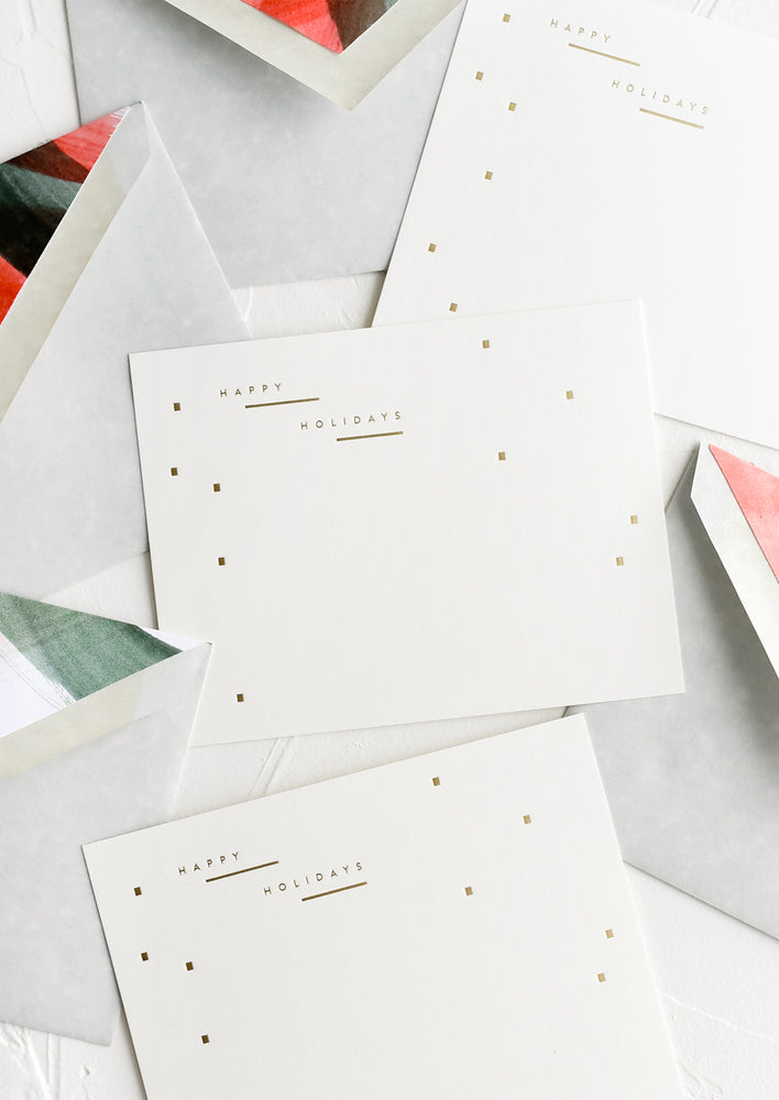 A set of holiday notecards with painted red and green envelope liners.