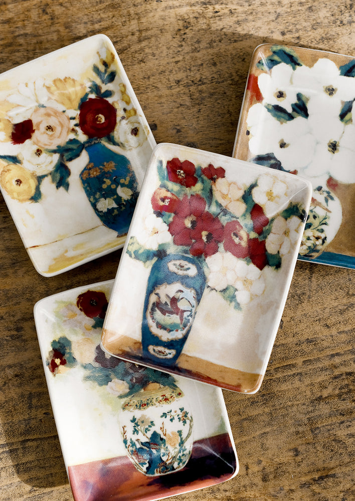 Rectangular ceramic dishes with still life flower in vase print, all slightly varied.