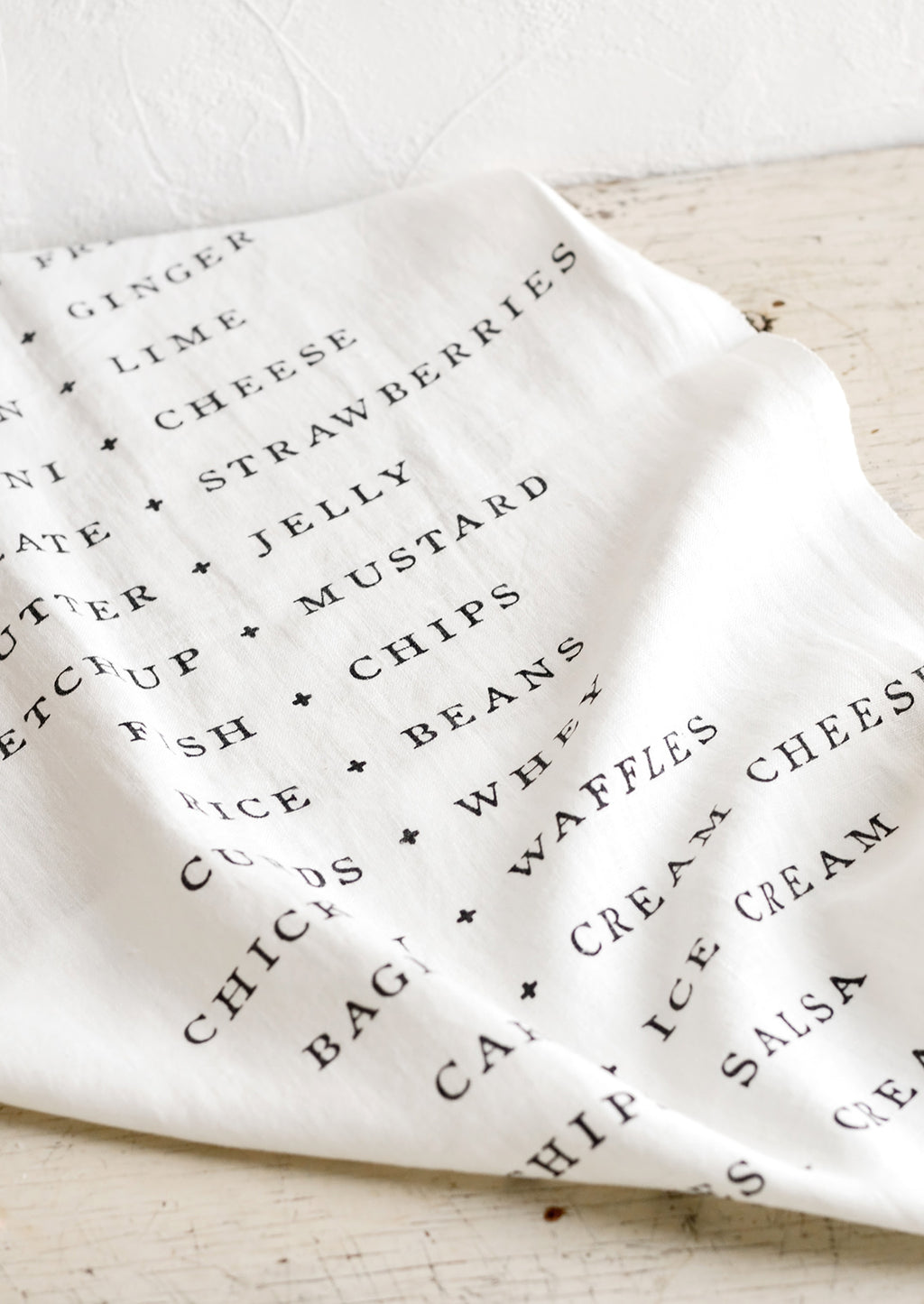 1: A white table runner with names of food pairings listed opposite each other.