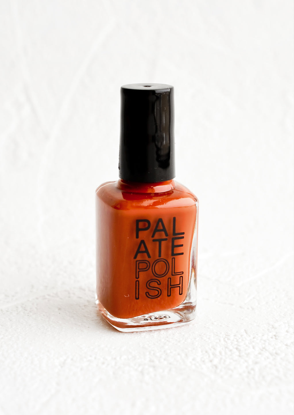 Cinnamon: A bottle of nail polish in rust red.
