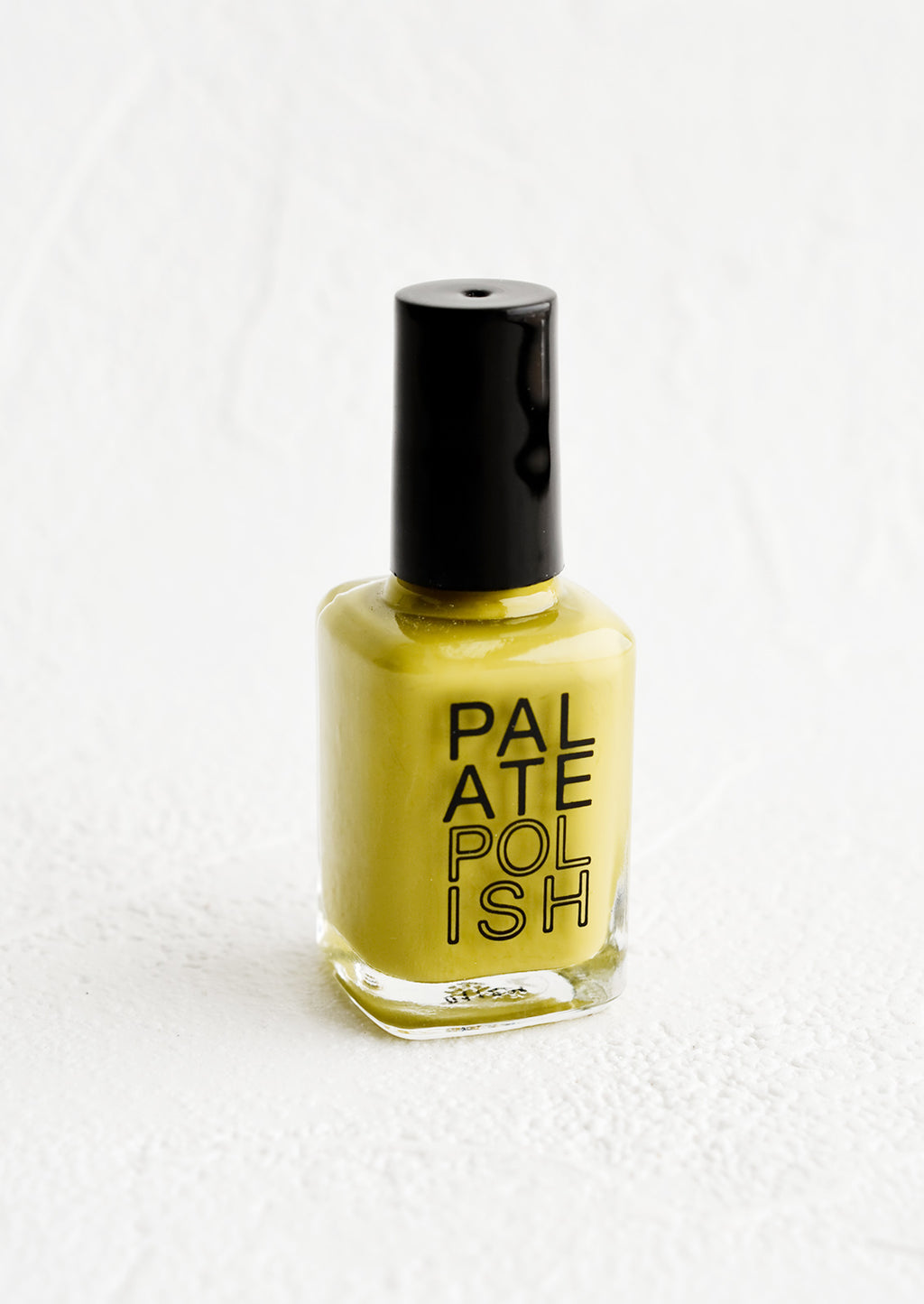 Sage: A bottle of nail polish in chartreuse.