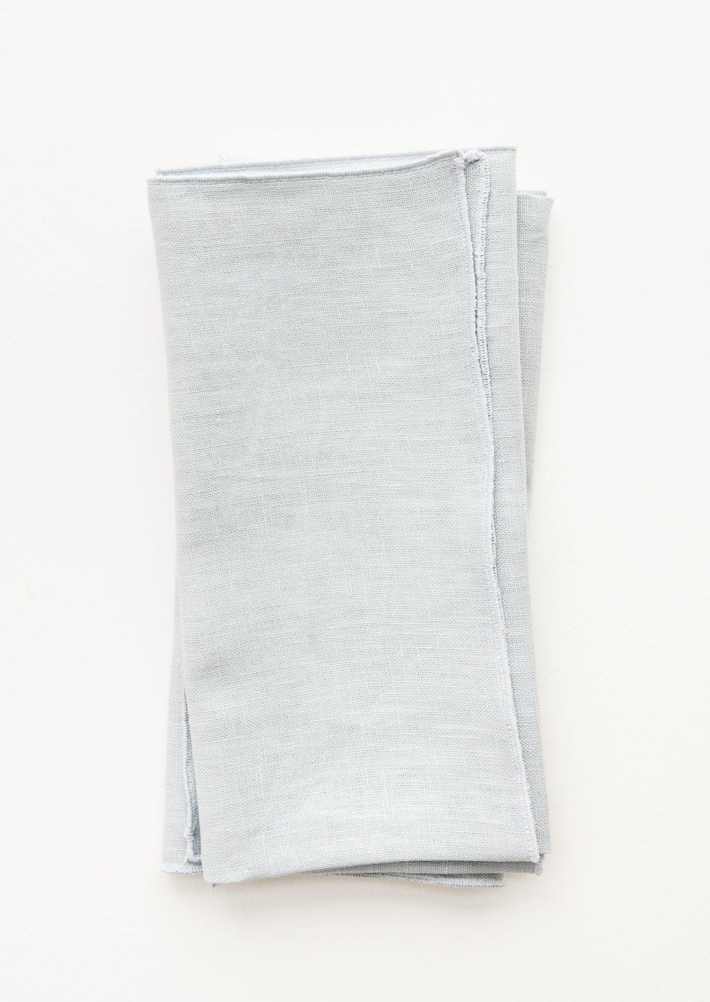 Mist: Pair of folded Linen Napkins in Misty Blue.