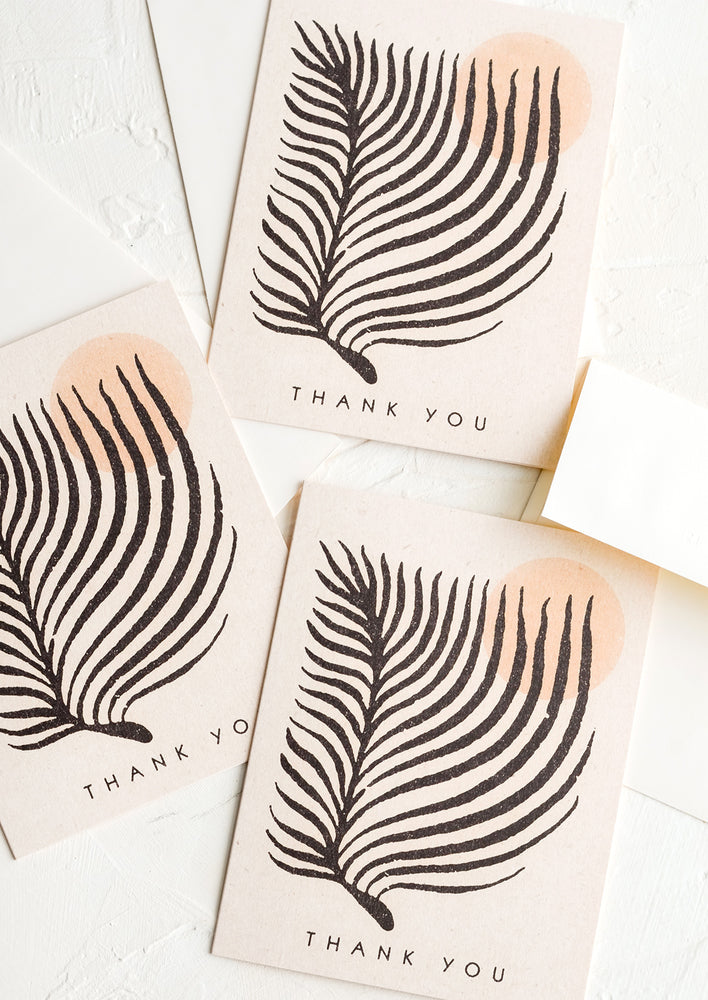 Three identical thank you cards with image of palm leaf and sun on front.