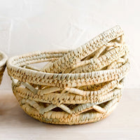 2: Nesting storage bowls made from woven palm leaf.