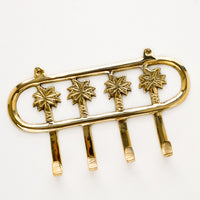1: Wall mountable hook rack with 4 palm trees extending into hooks, made in brass
