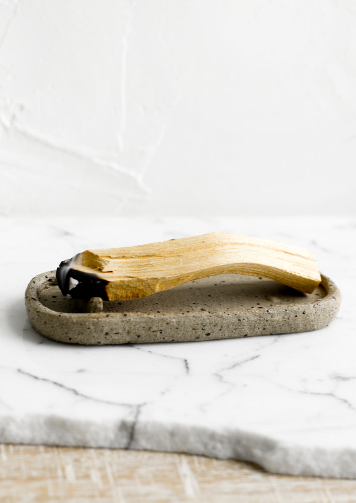 An oval shaped ceramic dish for burning palo santo.