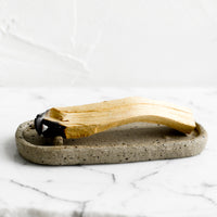 2: An oval shaped ceramic dish for burning palo santo.