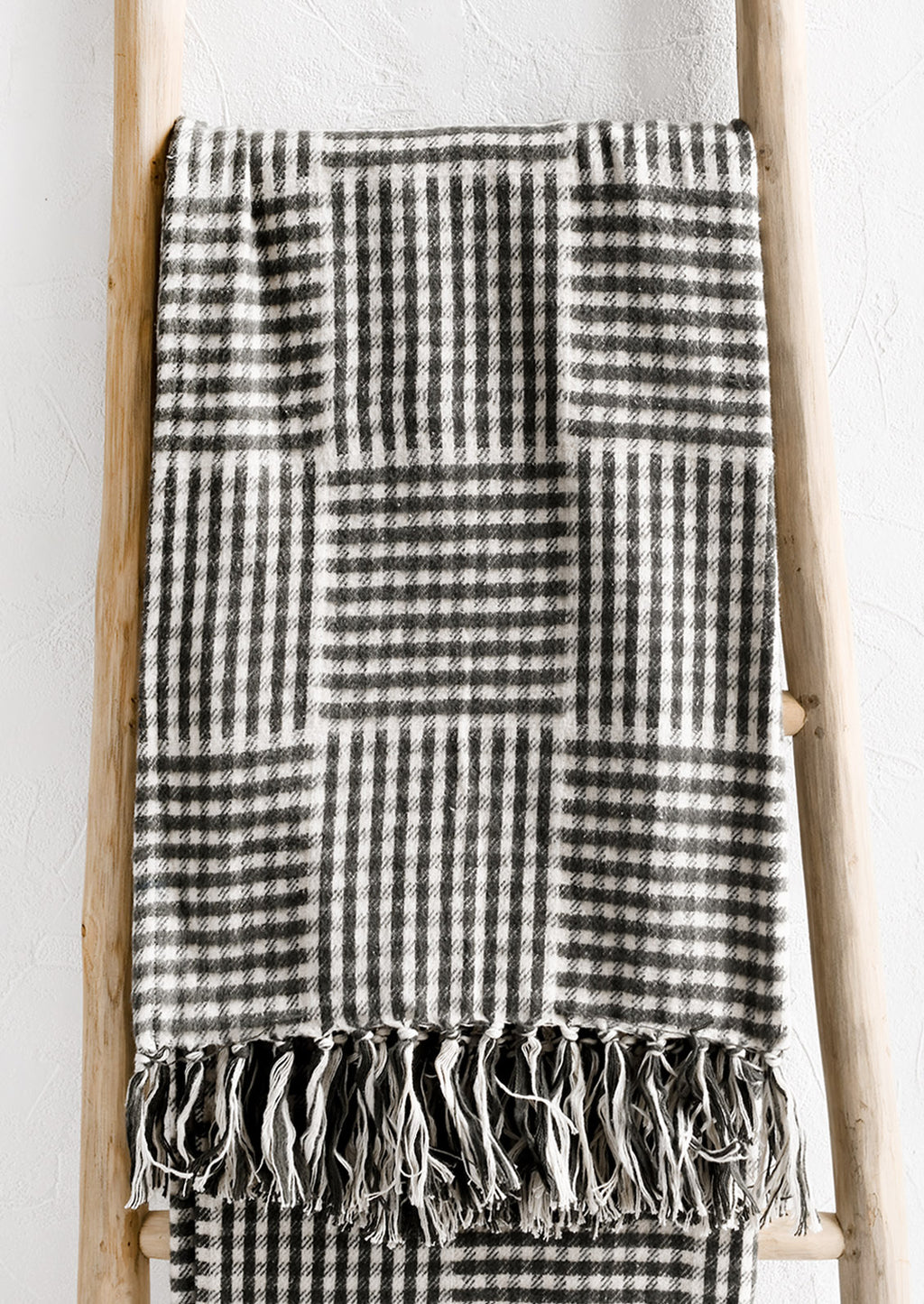 1: A black and white paneled check throw blanket.