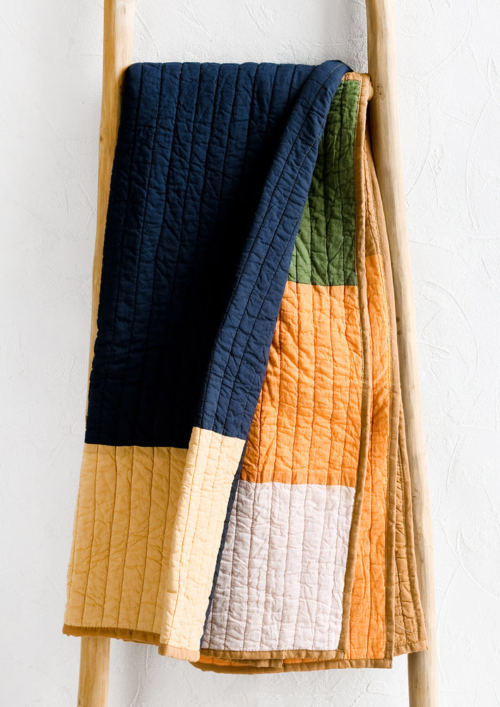 A colorblocked cotton quilt.