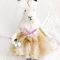 Bell: A felted holiday ornament of a bunny wearing a dress, holding a jingle bell.