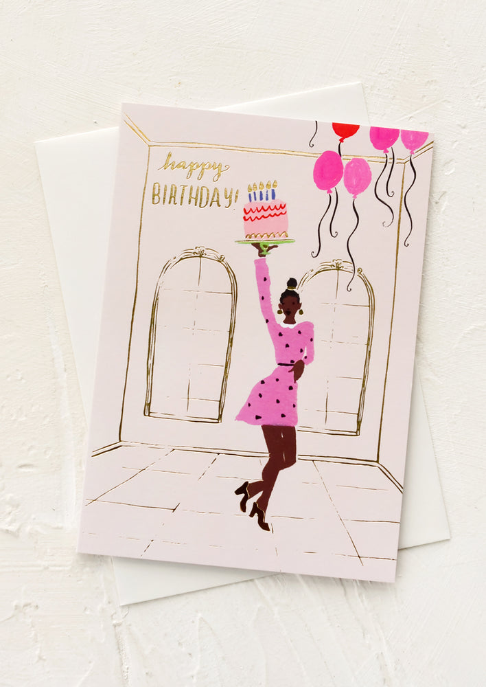 1: A greeting card with illustration of a black woman in a party dress holding a birthday cake.
