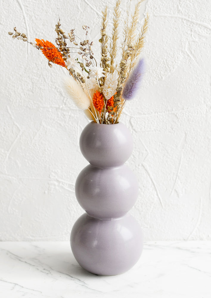 A lavender ceramic bud vase with stacked bubble shape.