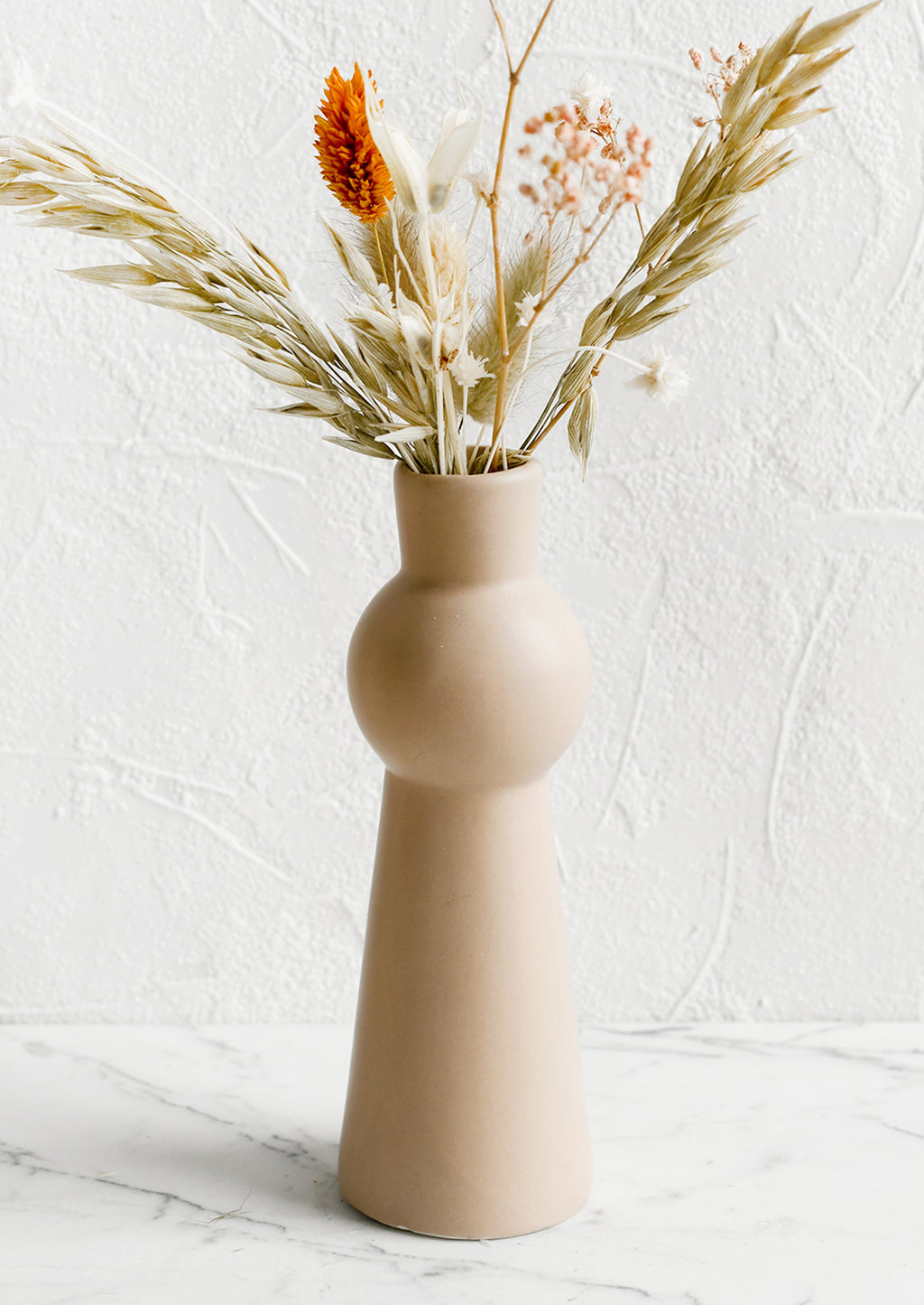 Rose Cream: A blush ceramic bud vase with tapered shape.