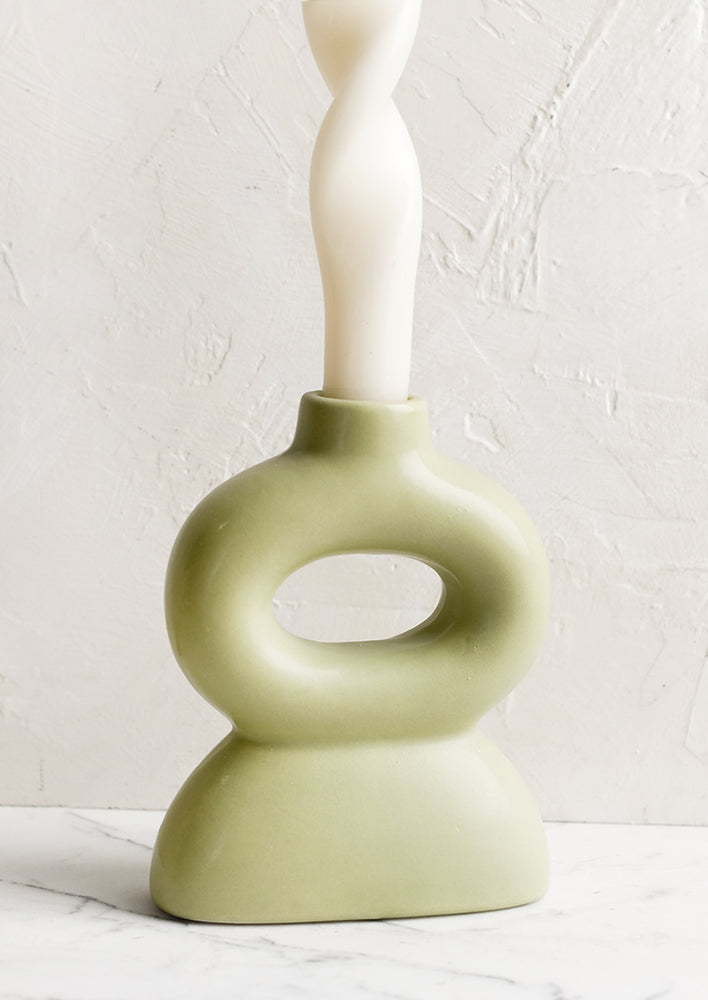 Honeydew: A curvy shaped taper candle holder in honeydew green.