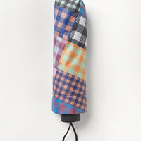 1: A nylon umbrella in checkered patchwork print.