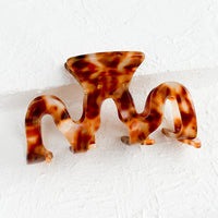 Cowrie Speckle: An acetate hair clip in squiggle shape in brown marble.